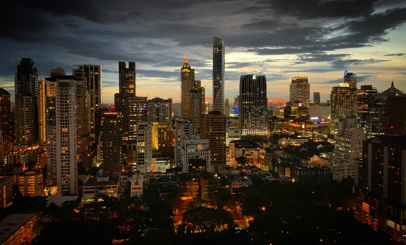 Bangkok skyline seen from a high rooftop viewpoint at golden hour