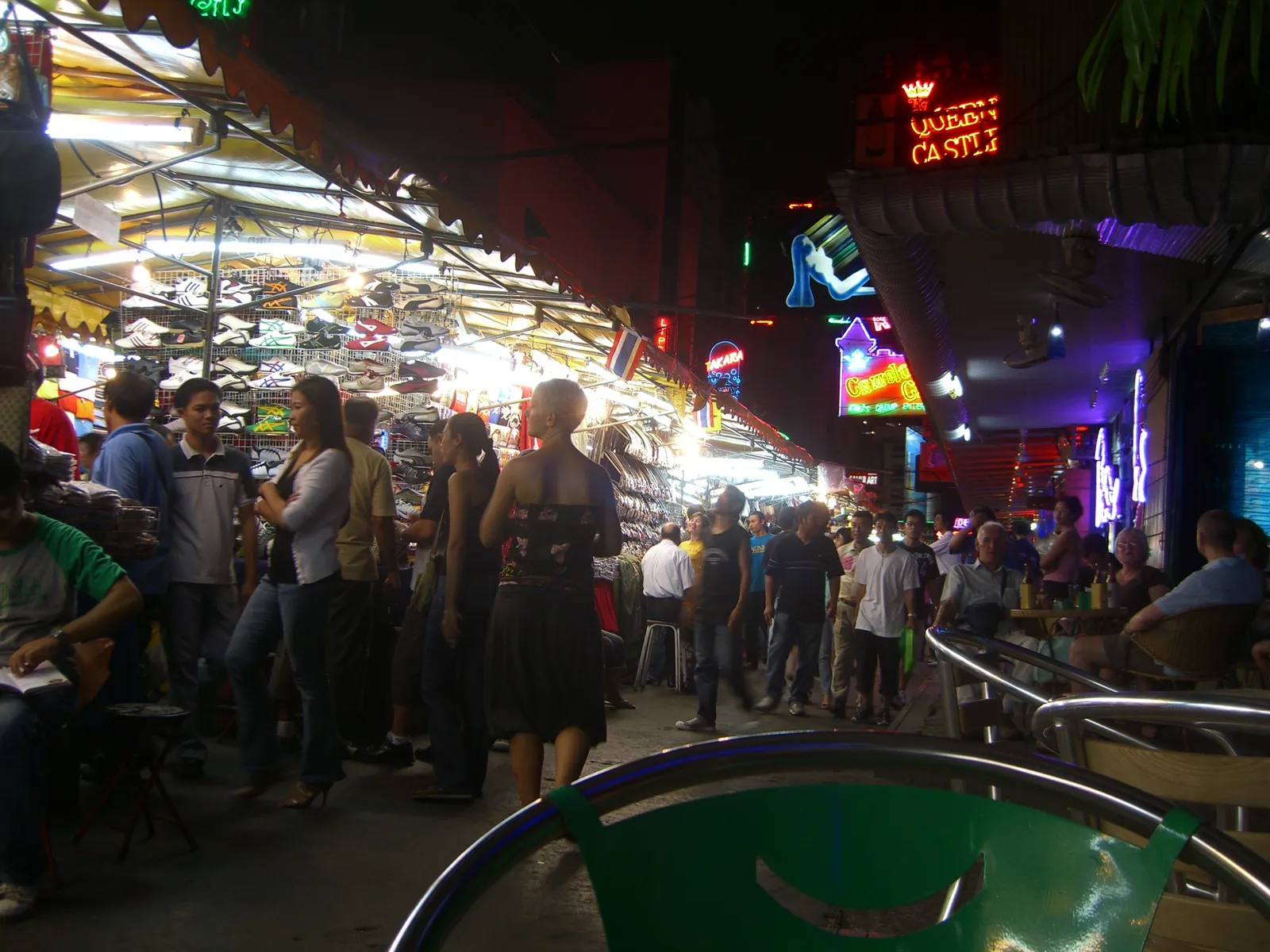 Night-market stalls under neon on Patpong, Bangkok