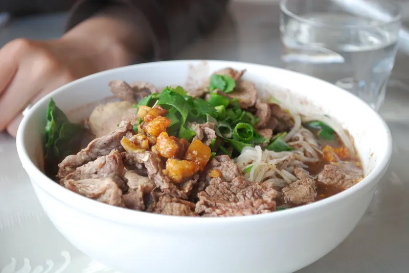 A small bowl of boat noodles served at a Bangkok noodle shop
