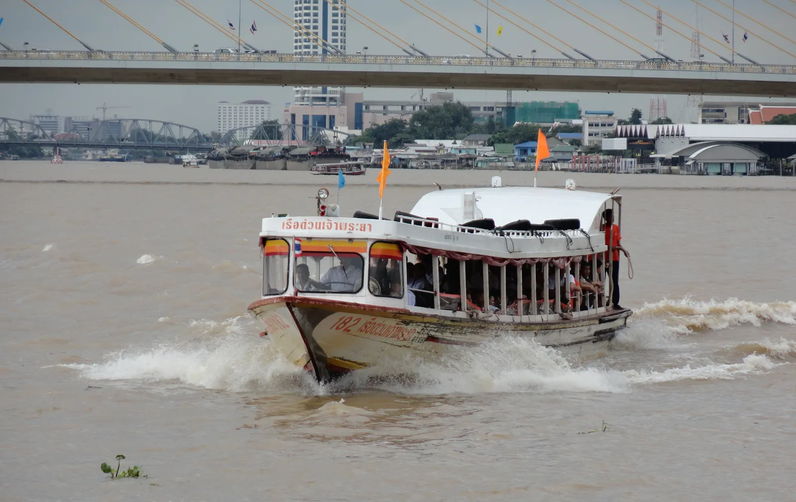 Chao Phraya Express Boat carrying passengers along Bangkok's river