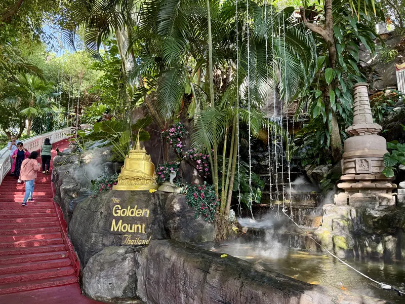 Tree-shaded steps and bells climbing toward the Golden Mount at Wat Saket