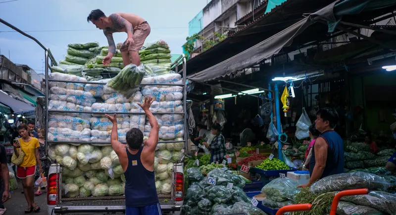 Fresh produce and vendors at Khlong Toei Market in Bangkok