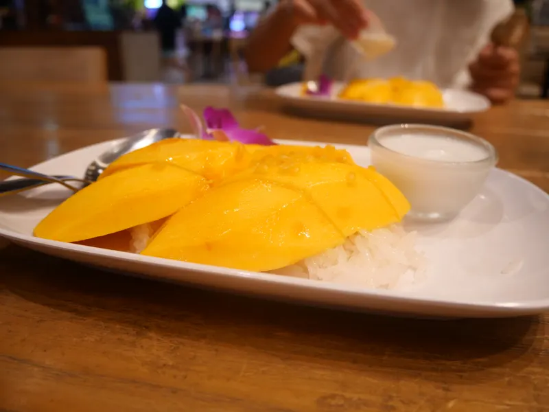 Mango sticky rice served with coconut cream in Bangkok