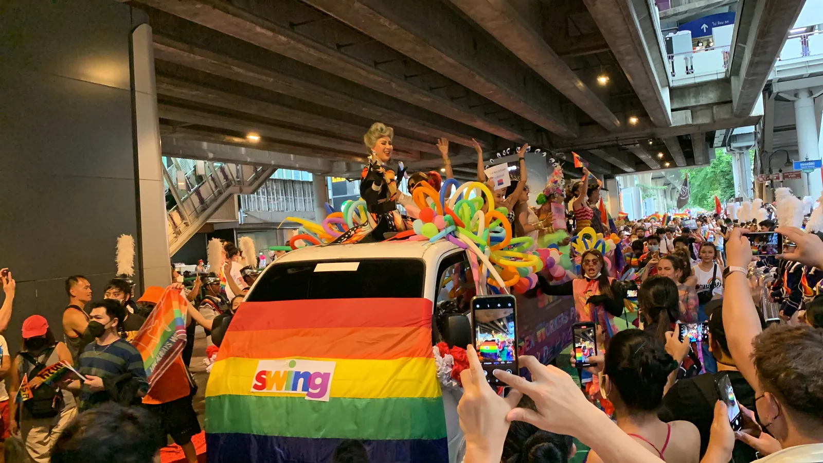 Bangkok Pride parade with rainbow flags on Silom Road